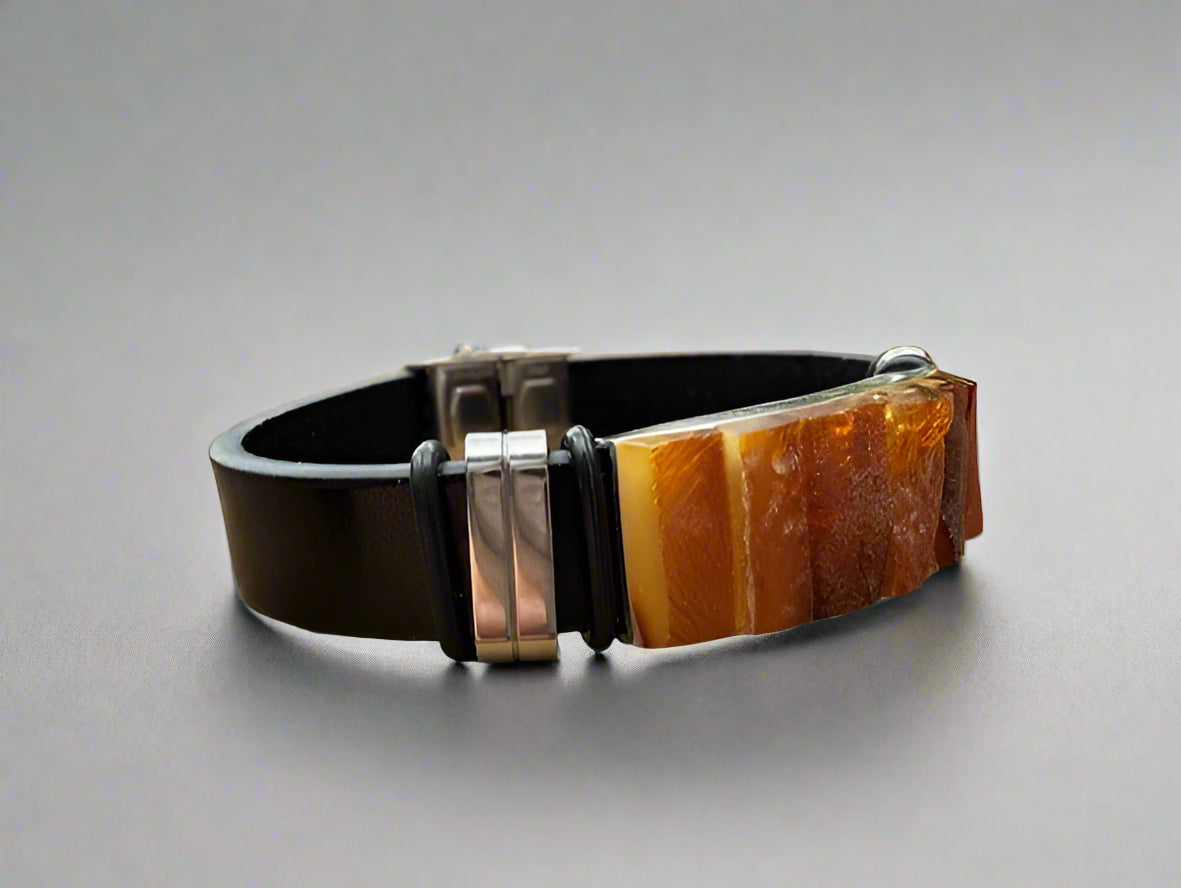 Bracelet with brown leather strap and wooden accent on a gray background