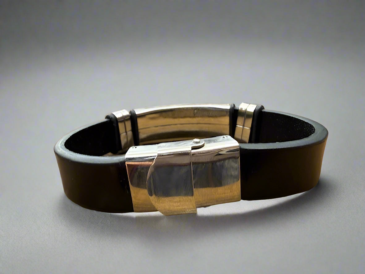 Black leather bracelet with silver clasp on a wooden surface