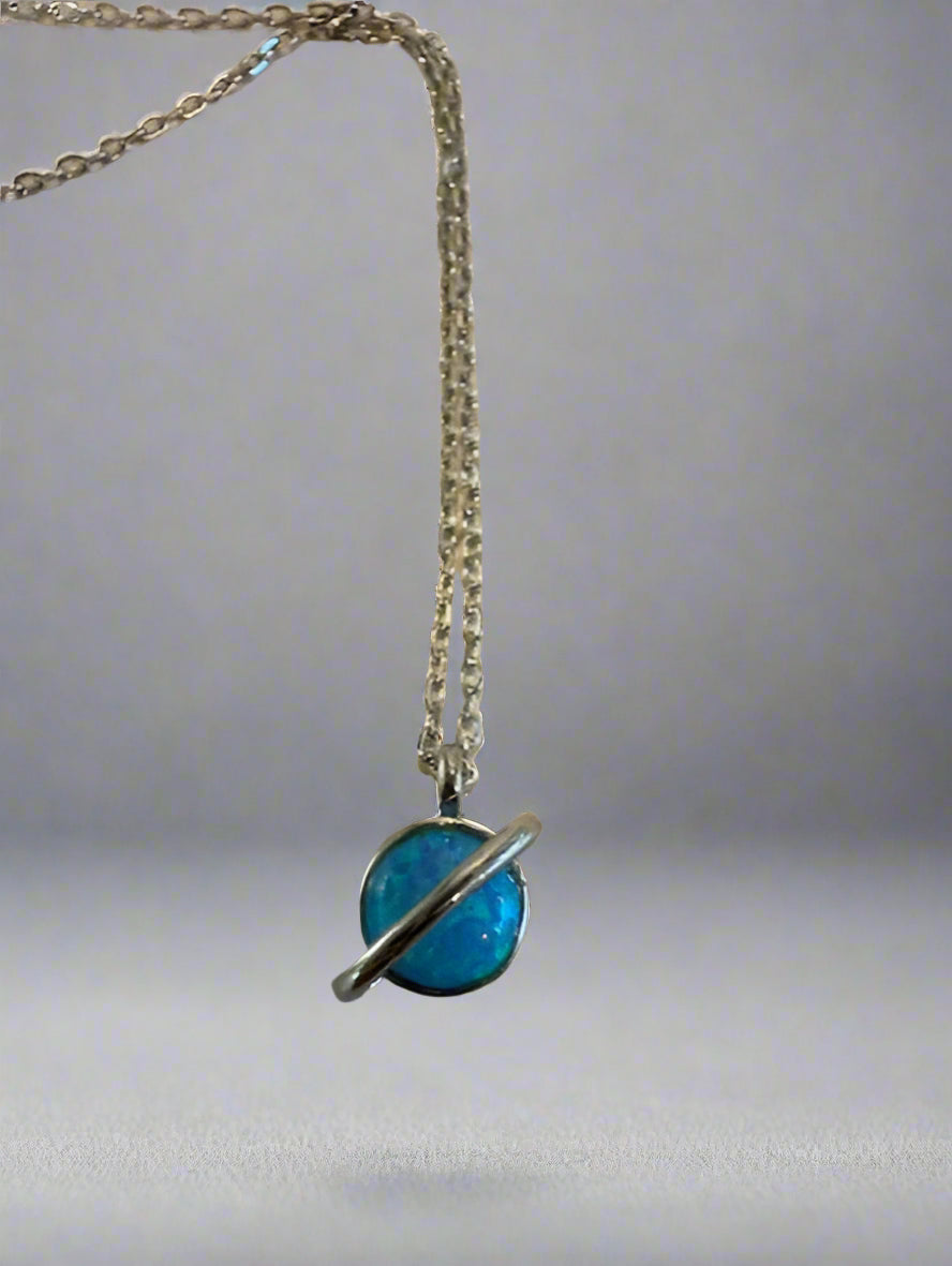 Necklace with a blue pendant on a beige background