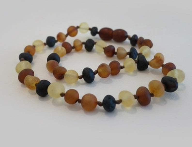 Multicolored beaded necklace on a light background