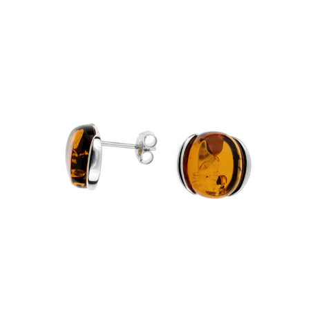 A pair of round cognac amber earrings with silver posts and silver clasps, set against a white background.