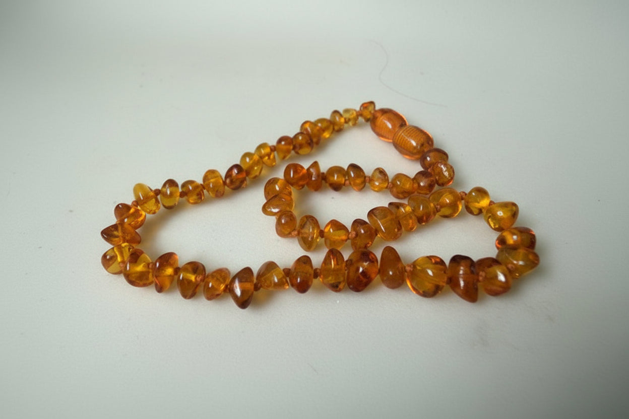 Amber necklace on a light gray background