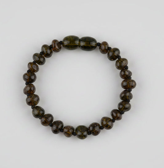 Beaded bracelet with brown and black stones on a textured beige background
