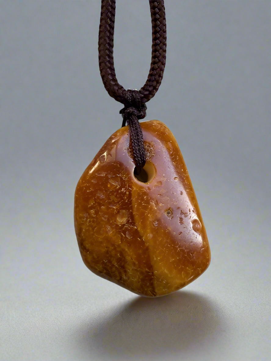 Baltic amber pendant on white background 