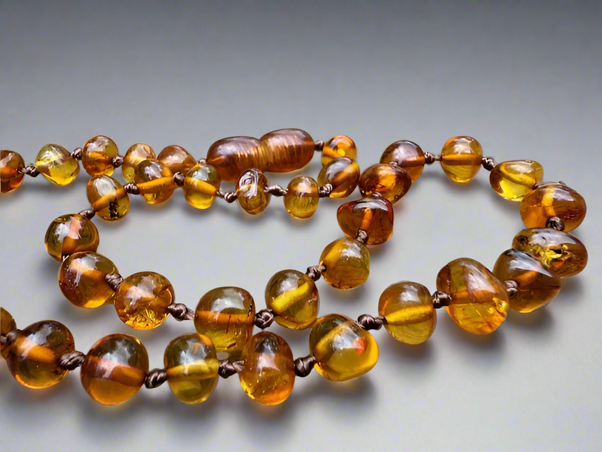 Amber teething necklace on a wooden surface
