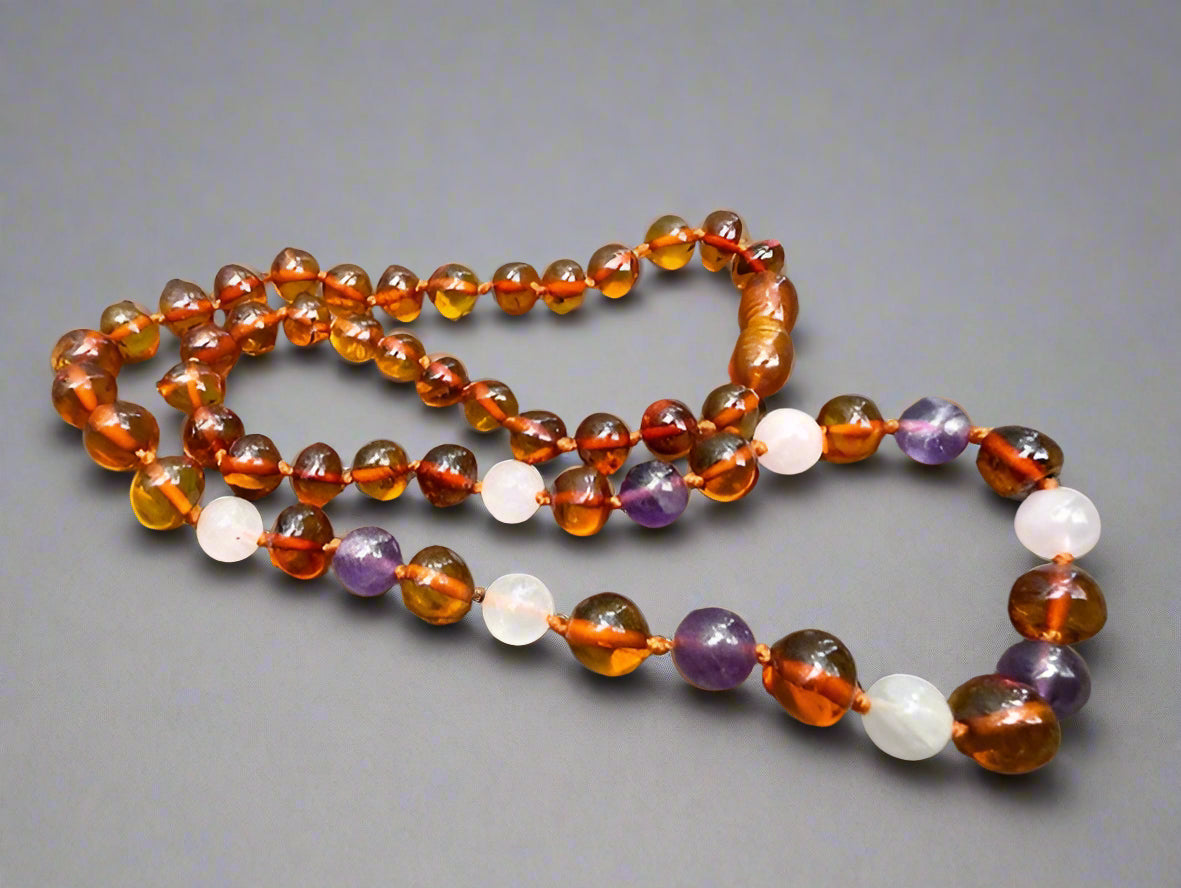 Colorful beaded necklace on a textured surface