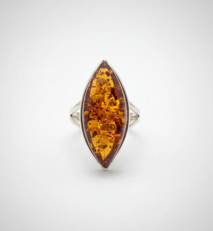 Ring with a marquise-shaped amber stone on a white background