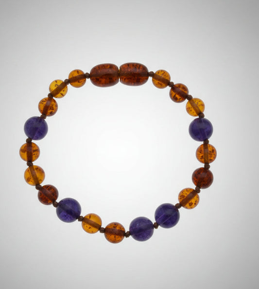Beaded bracelet with brown, blue, and orange beads on a textured white surface