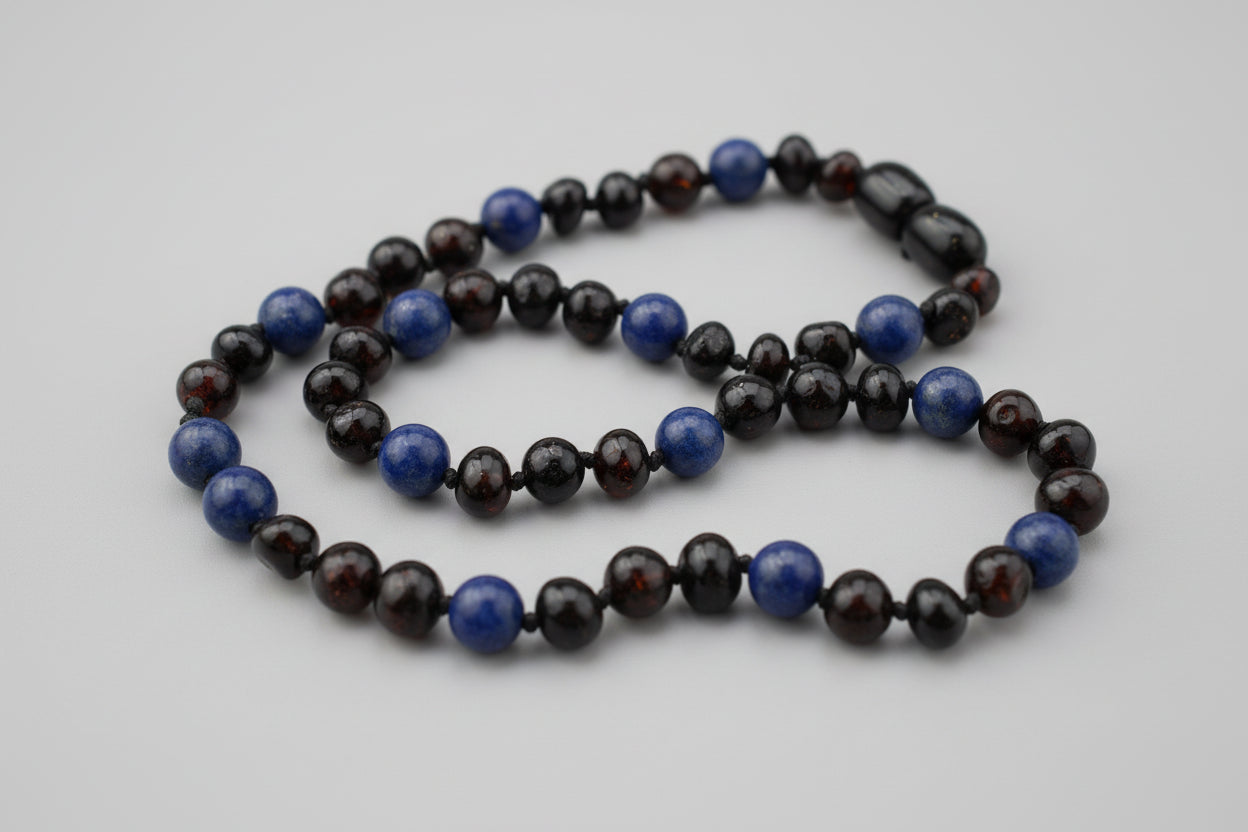 Necklace with blue and black beads on a wooden surface