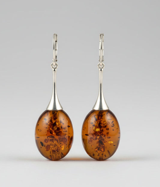 Amber earrings on a wooden surface