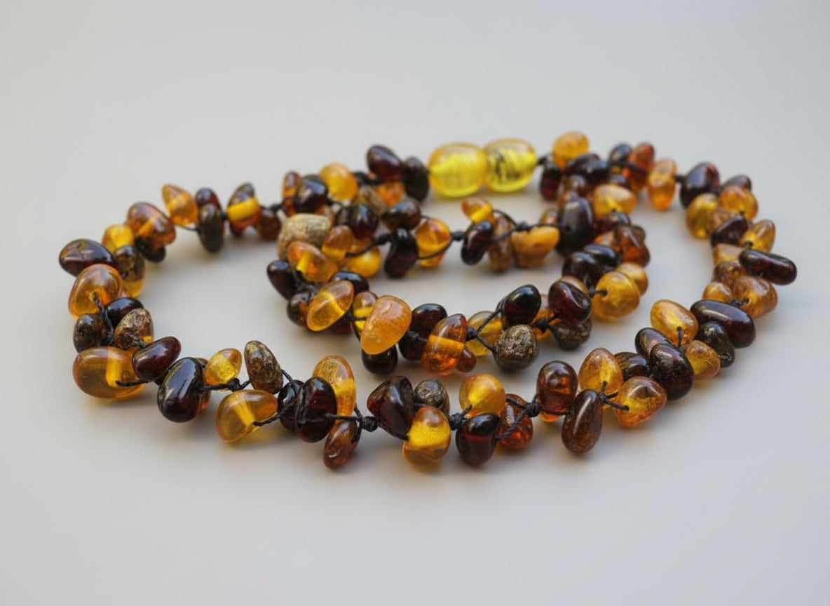 Necklace made of amber beads on a light gray background