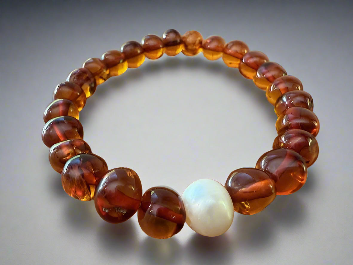 A bracelet made of cognac amber beads and a white baroque pearl.