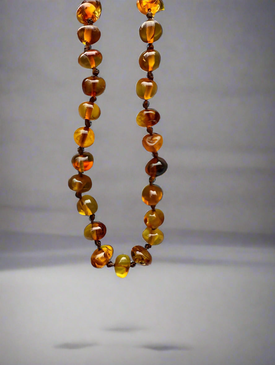 Amber necklace on a striped fabric background
