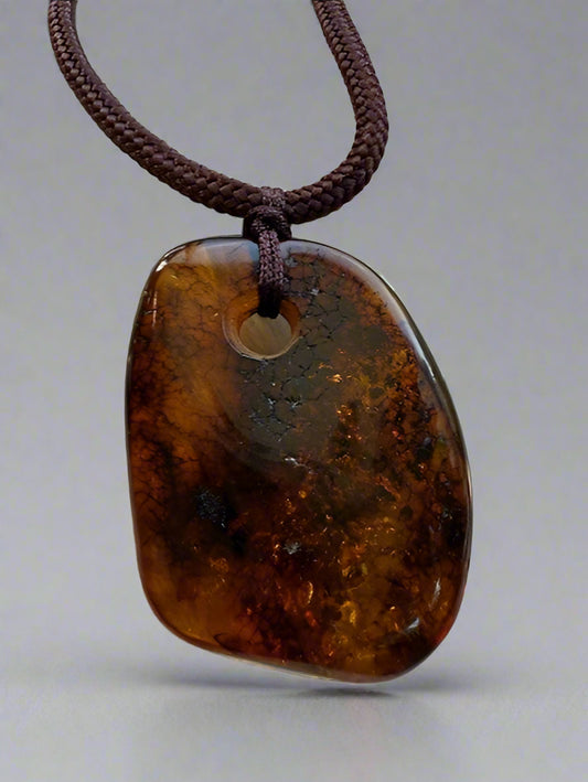 Brown pendant necklace on a textured surface