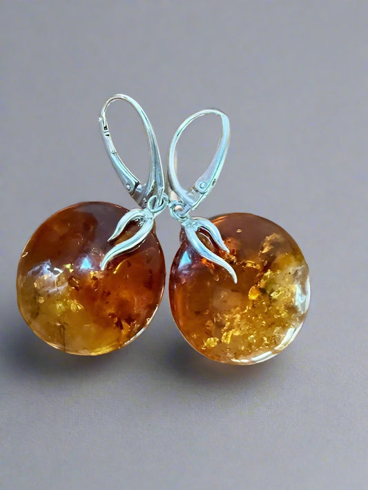 Amber earrings on a wooden surface