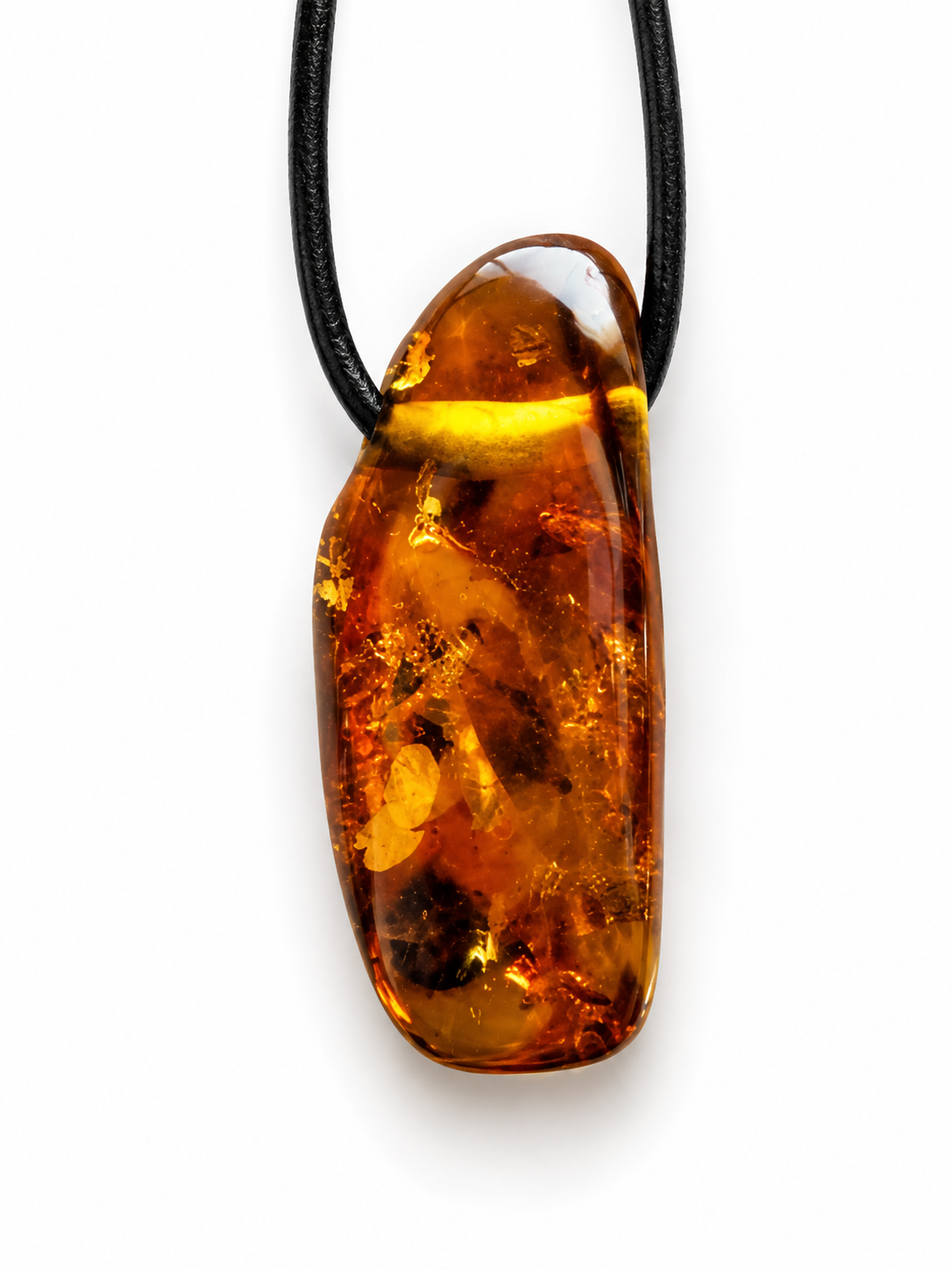 Amber pendant on a black cord against a white background