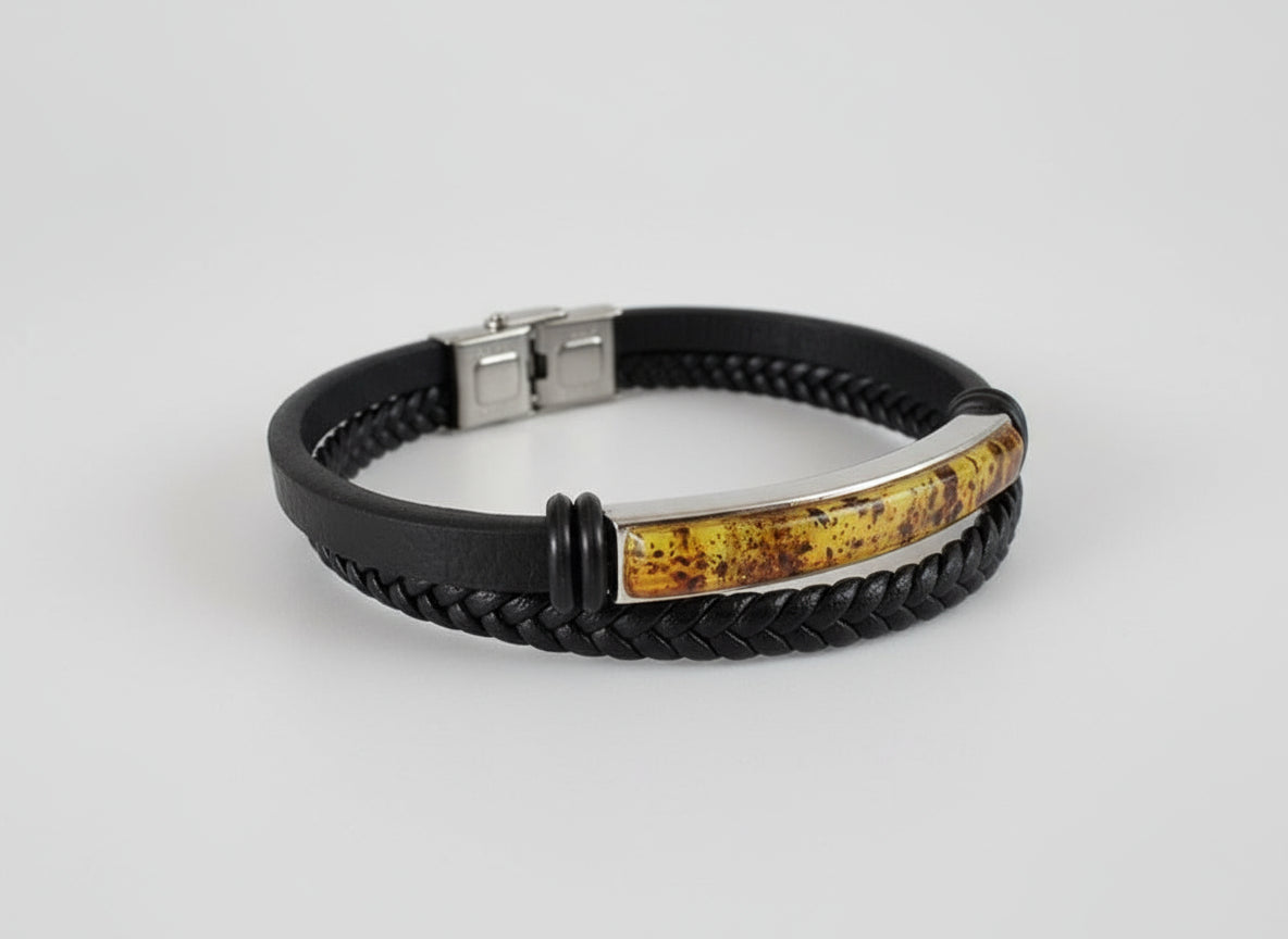 Black braided leather bracelet with a metallic clasp on a light gray surface.
