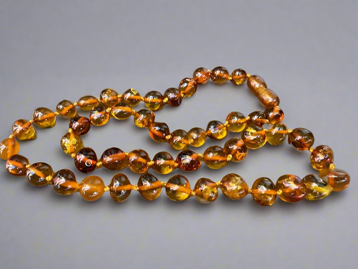 Amber teething necklace on a wooden surface