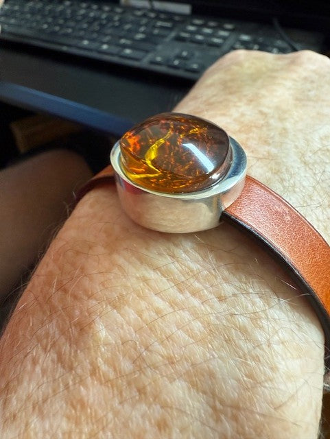 Close-up of a large round amber stone bracelet