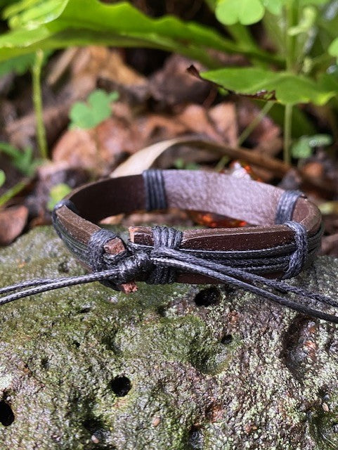 Brown leather adjustable strap on a rock 