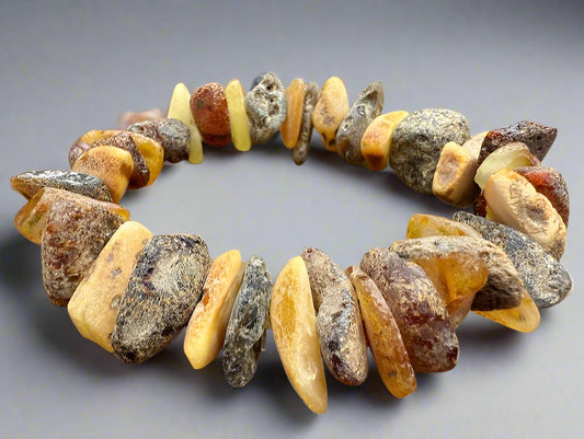 Necklace made of amber beads on a gray background