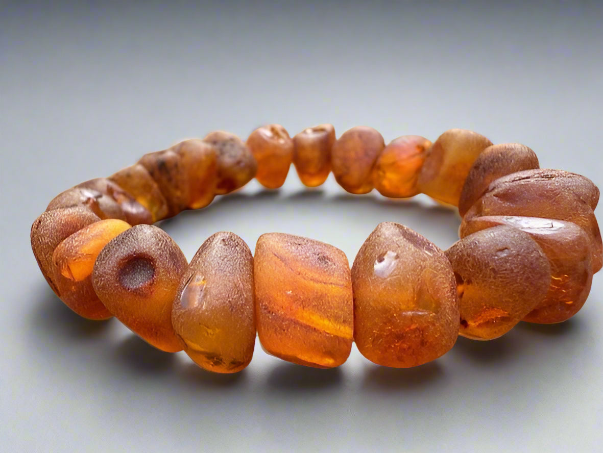 Amber beaded bracelet on a wooden surface
