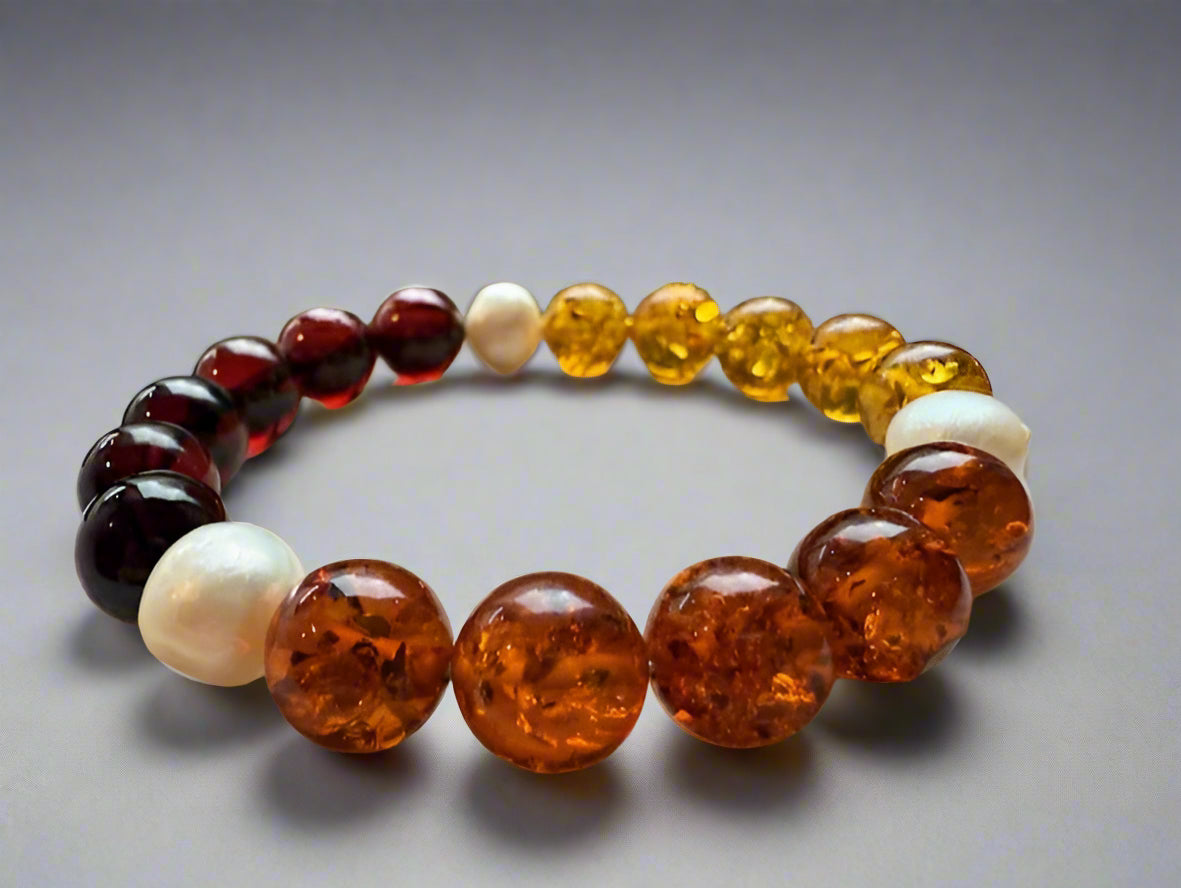 Multicolored beaded bracelet on a textured surface with a blurred natural background