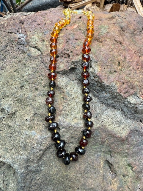 Necklace with amber beads on a stone surface