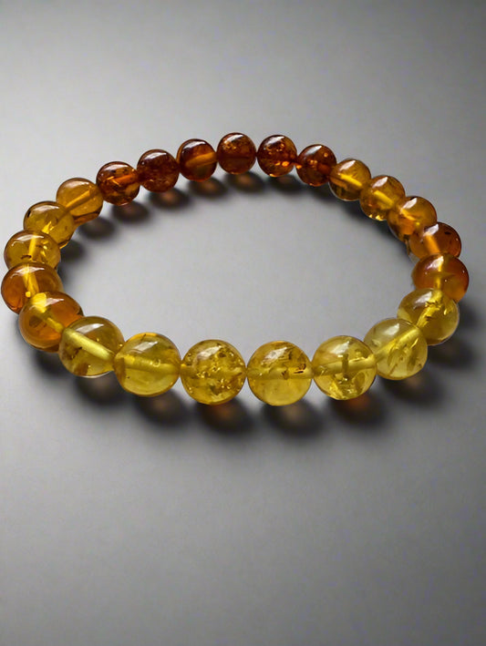 Amber beaded bracelet on a textured surface