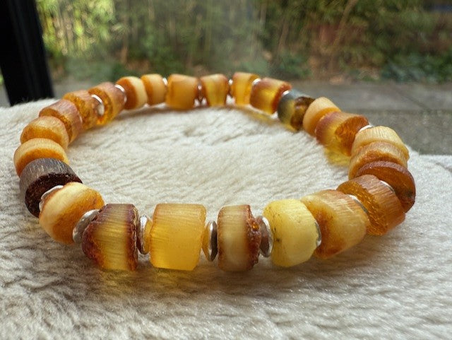 Beaded bracelet with brown and yellow beads on a textured surface