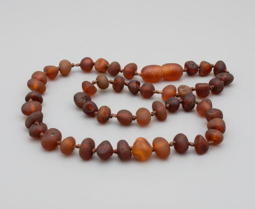 Necklace with amber beads on a wooden surface