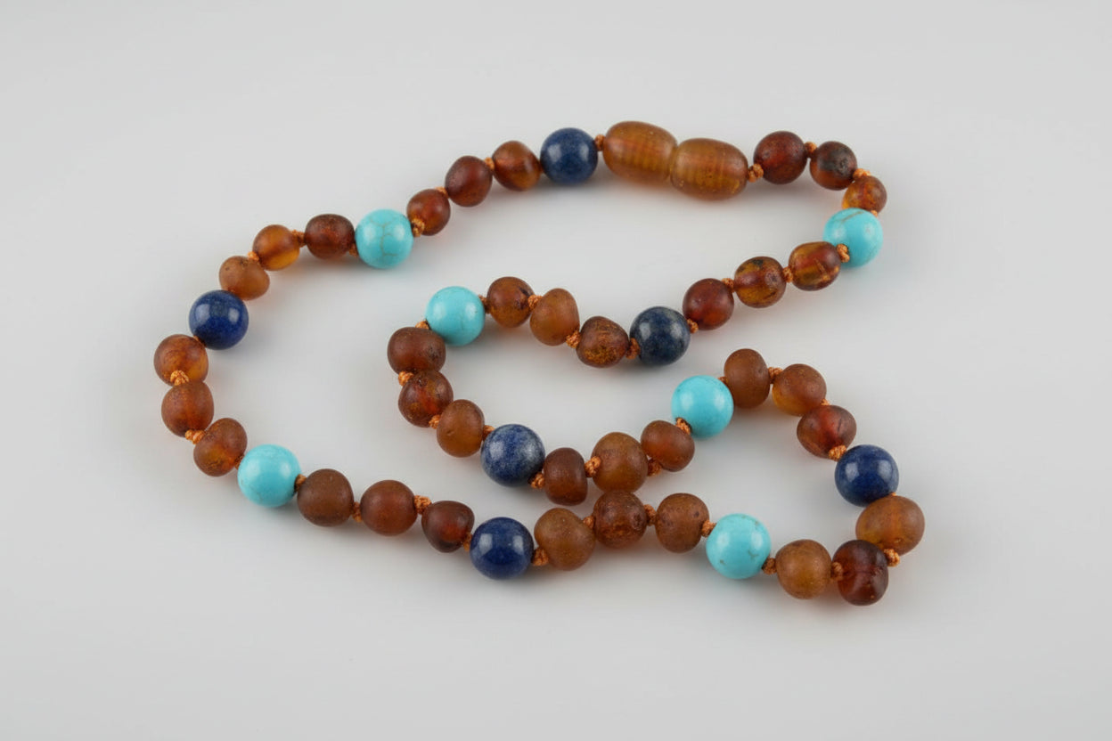 Necklace with brown, blue, and turquoise beads on a beige surface