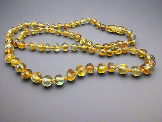 Amber beaded necklace on a wooden surface
