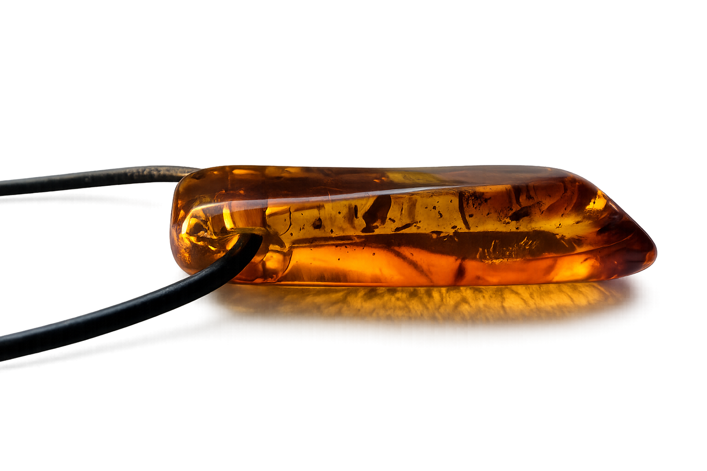 Amber-colored pill on a reflective surface with a dark background