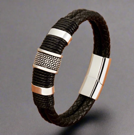 A black leather men's bracelet with two rope bands and sleek silver accents, displayed against a grey background.